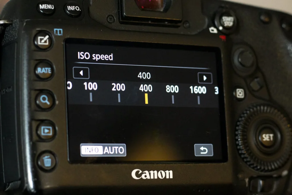 Adjusting the ISO speed on a Canon DSLR.